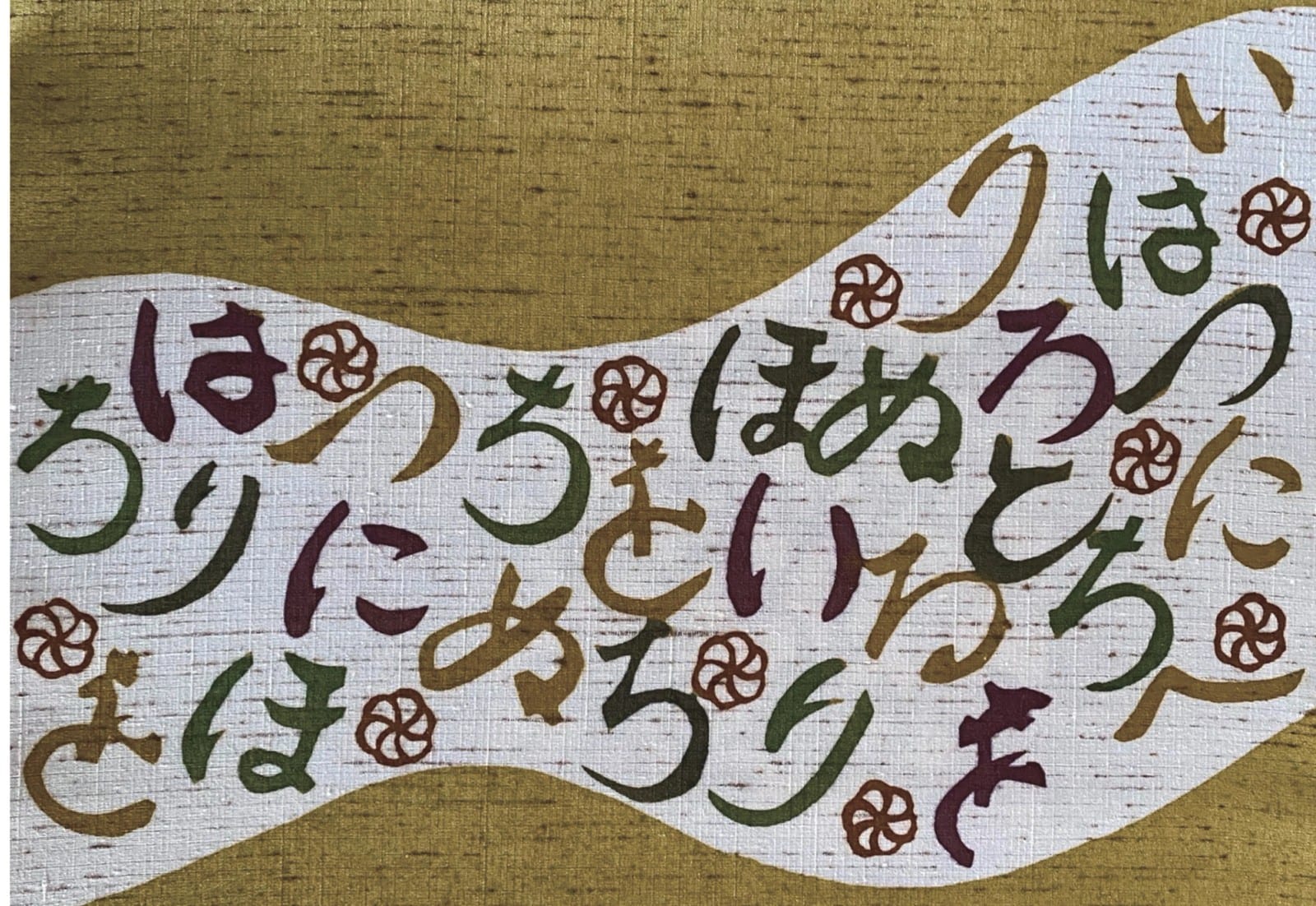 白い帯状の地に、いろは歌のひらがなと梅の花を染めた作品